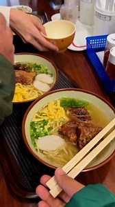 Okinawa soba (沖縄そば) is a beloved noodle dish from Okinawa that, despite its name, is made from wheat flour rather than buckwheat, giving it a chewy texture similar to ramen or udon. Served in a clear, savory pork- and bonito-based broth, it is typically topped with stewed pork belly (sanmainiku), fish cake (kamaboko), and green onions, though variations like soki soba use pork spare ribs. With regional styles across Okinawa’s islands, Okinawa soba is both a festive dish enjoyed during celebratio