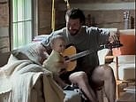 Sam Hunt plays acoustic guitar with his one-year-old daughter Lucy on the couch