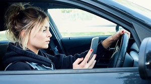 Using a hands-free mobile while driving must be made illegal, MPs demand