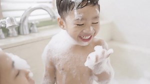 boy taking a bath in the tub take bath he plays with bubbles