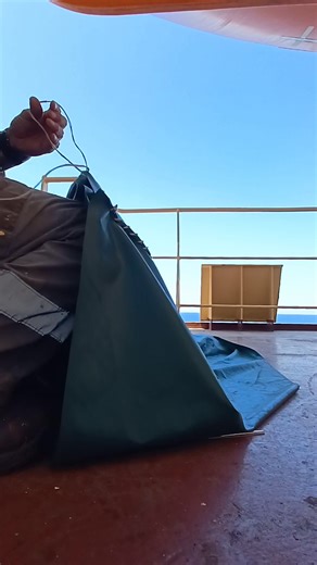 Sewing a cover for lifeboat embarkation ladder, seamans life #SeafarersLifeOnboard #SeafarersPH #SeafarerJobs #seamanslifeonboard #seafarersjob #fyp #seafarerslife #Seafarer #SEAMAN | Mandaragat