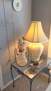 Glass top wrought iron side table $48 light green lamp with sculpted flowerettes and green silk shade with beaded fringe $110. Next to it is a ceramic birdie planter $25 | The Garage & The Garage Girls - Antiques, Suffern, NY