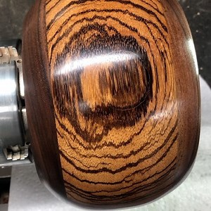 43 reactions · 15 comments | Hours of sanding to 600 grit, a friction polish, and 2 coats of citrus oil and beeswax. Now I just have to convince myself to cut the groove to make it a yarn bowl. Maybe I’ll just drill a hole instead... #handturned #zebrawood #blackwalnut | Yarn Dragon | Facebook
