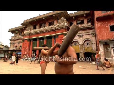 Indian wrestlers practice weights early morning at Kolkata akhada