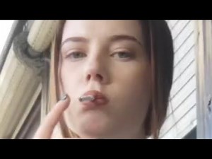 beautiful fetish girl smokes cigarette and throws cigarette away