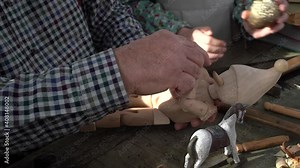 The creation of Pinocchio in the carpentry workshop of the woodworker Gepetto Papa Carlo . Children's fairy tales . A wooden doll with a long nose .