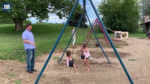 Desantis and his wife Casey push their children on the swings at the park.