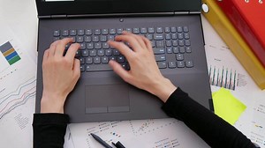 Download Female using laptop computer on office table for free