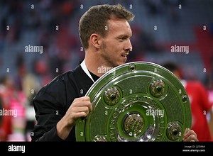 Bavaria, Munich: 08 May 2022,  Soccer: Bundesliga, Bayern Munich - VfB Stuttgart, Matchday 33, Allianz Arena, Bayern coach Julian Nagelsmann celebrates with the championship trophy after the match. IMPORTANT NOTE: In accordance with the requirements of the DFL Deutsche Fußball Liga and the DFB Deutscher Fußball-Bund, it is prohibited to use or have used photographs taken in the stadium and/or of the match in the form of sequence pictures and/or video-like photo series. Photo: Sven Hoppe/dpa Stoc