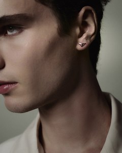 A Prada nano triangle earring is a subtle icon and a nod to ubiquity. Discover more at https://tinyurl.com/2p98mapd. #PradaFineJewelry #Prada | Prada