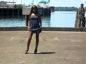 Hot Chocolate Model Yarrvo poses on waterfront in summer dress for Realamericanmodels.com.