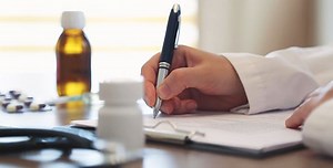 Nurse Writing Medical Prescription