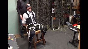 Man in suit tied to chair