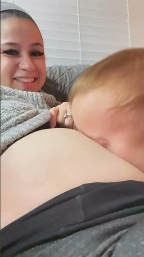 Baby blows raspberries on mom's pregnant belly!