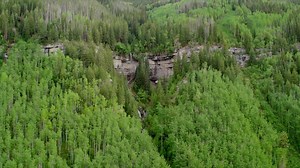 This three-level Vail home has light hardwood floors flanked by floor...