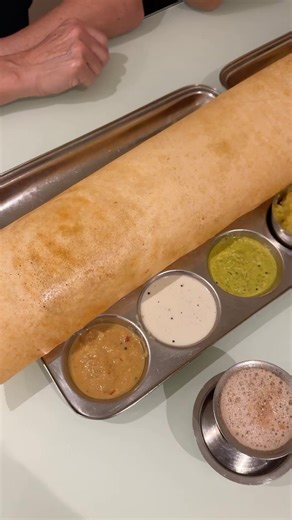 Giant Dosa in Doha! 🤩 Amazing Giant Family Dosa plus Mini tiffin dosas at Chettinad @aryaasqatar the OG dosa destination - choose sweet, pongal or Kitchadi or Upma, Mini Idly, Vada, Gee Roast or Mini Masala Dosa, Poori, a variety of Chutneys, Sambar, all enjoyed with Chai Tea 🔥🙌 These crispy dosas were so rewarding and delicious and staff were excellent. Every bite is a celebration of flavor, tradition, and the timeless allure of South Indian cuisine. Personally I loved the Ghee Roast in the 