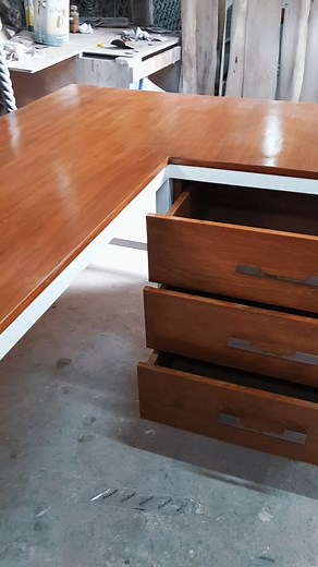 Elevate your workspace with our sleek and functional L-shaped table. Crafted from solid mahogany and finished in a sophisticated two-tone white and natural wood stain, complete with convenient drawers for seamless organization. #Persquare #PersquareWoodworks | Persquare