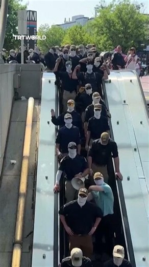 Masked group marches through Washington DC, chanting "Reclaim America"