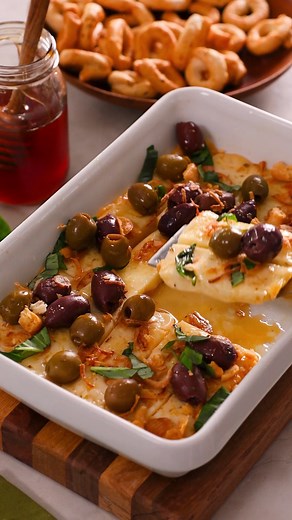 Feast your eyes on our Roasted Asiago with Hot Honey and Crispy Shallots. Imported Asiago, from Italy is sweet & nutty. We've roasted it until creamy and smooth and added a sweet and salty topping. It's the perfect party appetizer served with toasted Italian bread or crispy vegetables. Get the tasty recipe here: https://iloveimportedcheese.com/recipe/roasted-asiago-with-hot-honey-and-crispy-shallots/ | I Love Imported Cheese