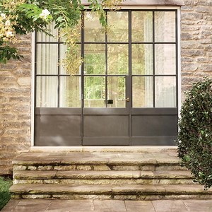 Long-lasting materials mean you can adorn your door with colorful faux flowers and greenery – without any of the upkeep. | Frontgate