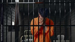 Sad Asian Male Prisoner In Handcuffs Crying While Standing In Prison, The Criminal Repents And Cries