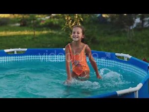 Little Girl Splash in the Pool in the Garden