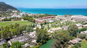 Water channel between Moraitika and Messonghi villages, Corfu Island in Greece, view with Messonghi Beach resort, 4k video