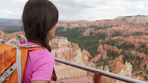 Hiker woman walking and backpacking in Bryce Canyon hiking looking and enjoying view during her hike. Bryce Canyon National Park landscape, Utah, USA. Multiracial Asian Caucasian woman living healthy.