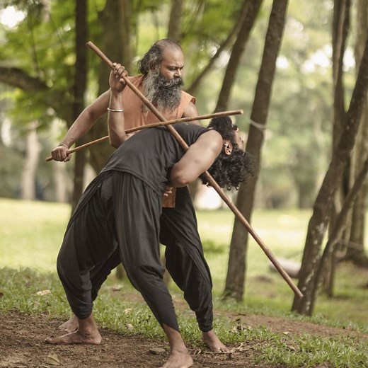 Transform into a warrior with Gurukkal's self-defense moves! Kalaripayattu, originating from Kerala, India, is one of the oldest martial arts in the world. It emphasizes self-defense through various techniques, including powerful strikes, kicks, locks, and holds. Practitioners also train with traditional weapons such as sticks, daggers, and flexible swords. The art form focuses on stances for stability, agile footwork for evasion, and body conditioning for strength and flexibility. This holistic