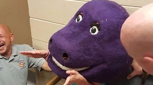 Teenager gets stuck in giant Barney mask