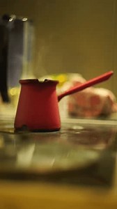 clip-3979536681-woman-hand-making-traditional-turkish-coffee-cezve