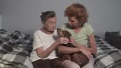 Theme family values and love for pets. Elderly daughter and senior...