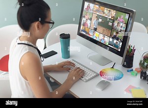 Asian girl using computer for video call, with smiling diverse elementary school pupils on screen. communication technology and online education, digi Stock Photo - Alamy