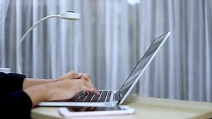 clip-3532714191-businessman-typing-on-laptop-table-there-smartphone