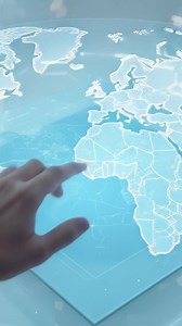 Vertical video: Appearing hand touching hologram map on transparent table drawing route, copy space | Premium Stock Video Footage