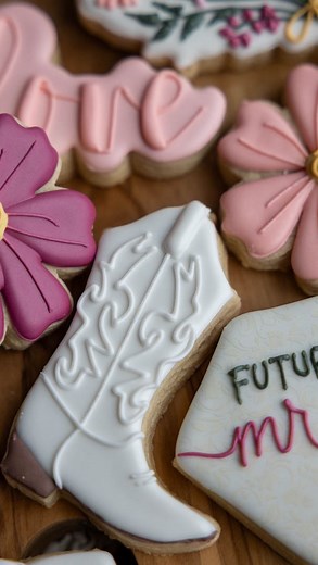 Boots, blooms, and bridal vibes! These custom cookies brought all the charm to a cowgirl-chic bridal shower… because who says you can’t have rhinestones and wildflowers? Hand-decorated with love, just like every wedding should be. #cowgirlcookies #bridalshowercookies #rusticglam #customsugarcookies #decoratedsugarcookies #cookieart #cowgirlchic #westernwedding #bridalshowerideas #tabithascookiejar #eriecolorado #coloradosugarcookies #denversugarcookies #weddingcookies #cookievideo #royalicingcoo
