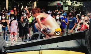 Woman ‘protestor’ defecates on an overturned police car in Uttah