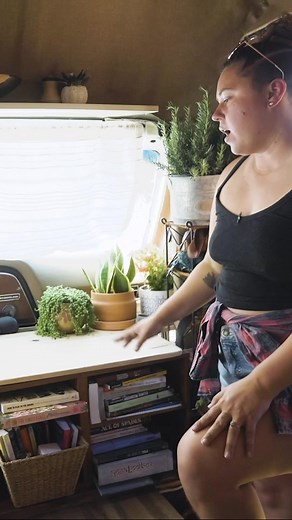 Queers In Transit turned the cab of their bus into a homey extension of their living room. What do you think about the way they utilized this space? Brilliant, right? #homeonwheels #tinyliving #tinyhousenation #tinyhometours #minimalism #homeiswhereyouparkit | Tiny Home Tours
