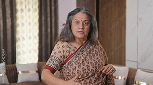 Aged Indian woman shouting on someone