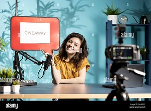 Jolly woman filming sponsored content, holding empty copy space sign, following script while talking to audience. Online star using cardboard bubble speech cutout to do influencer marketing Stock Photo - Alamy