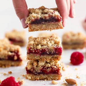 2.1K views · 33 reactions | Raspberry crumb bars are my favorite dessert bar for summer! ☀️ The sweet, yet tart raspberry preserves are sandwiched between a buttery oatmeal crust and crumble.  So easy & SO delicious! Recipe: https://www.ifyougiveablondeakitchen.com/raspberry-oatmeal-bars/ | If You Give a Blonde a Kitchen | Facebook