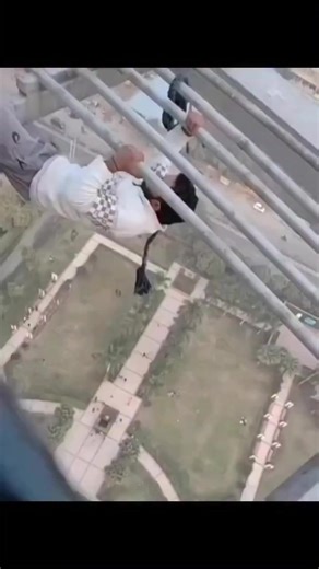Some random Indian guy at a lunch break climbing on a building. 30 minutes after this, he called your phone about your car's extended warranty. #india #crazy #funny #army #navy #airforce #marines #vetradiosyndicate #climbing #freelcimb #dangerous #why #callcenter | Vet Radio Syndicate