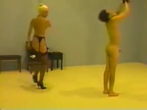 Mistress whipping her slave to punish him