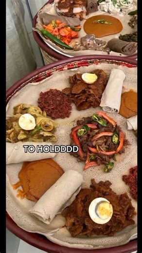 Injera cradles tales, while Doro Wat sings, each bite, a love letter to my taste buds it brings. From Kitfo's embrace to coffee's warm hug, oh, Ethiopian food, you're my dangerous love! 🍛❤️🎶 .. (📸: @habeshan_center) Join the Moya Fam for Ethiopian food content @balemoya .. #ethiopianfood #enjera #ethiopia #eritrea #habesha #eastafricanfood #africanfood #balemoya | Balè Moya
