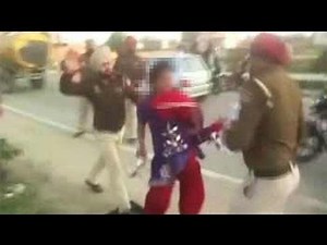 Two policemen suspended after woman beaten on camera
