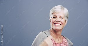 Rock, hand sign or face of a mature woman in studio on grey background for freedom, energy or emoji. Shaka, happy or excited senior person isolated for devil horns gesture, punk or funky rocker