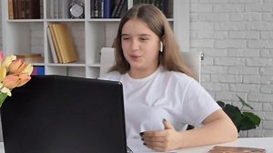 clip-1100683169-focused-woman-sit-desk-looking-laptop-learn