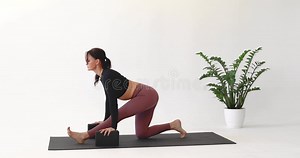 A Woman Performs the Ardha Hanumanasana Exercise, Warming Up before Performing a Full Longitudinal Split Stock Footage - Video of middle, position: 299381646