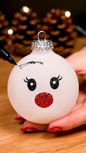 Baking Soda Reindeer Ornament Materials: Clear Ornament Bulb (plastic or glass), Polycrylic or Mop & Glo floor finish, Baking Soda, Black Permanent Vinyl or black oil-based paint pen, Red Permanent Vinyl or red paint/red pom-pom, White Paint Pen, Gold Glitter Foam Sheet, Dark brown felt, Light tan/pink felt, Mini Paper Flowers (red and white), White organza sheer ribbon, Hot Glue Gun Create a charming reindeer ornament that adds a festive touch to your holiday decor. This project combines baking