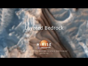 Layered Bedrock on Mars | NASA's Mars Reconnaissance Orbiter FriendsofNASA.org: Layered sediments are the key to the puzzle of Martian history. They tell us about the conditions that existed when the sediments were deposited, and how they changed over time. This image shows an eroded mesa made up of rhythmically layered bedrock that seems to indicate cyclic deposition. The layers are accentuated by recent dark sand deposits that have accumulated on the benches of the brighter sediments. The plat